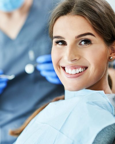 Male dentist and woman in dentist office Male dentist and woman in dental clinic